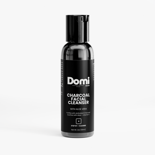 A bottle of Domi Skin Charcoal Facial Cleanser on a light gray background. The bottle is black with a black cap and a black label featuring white text.