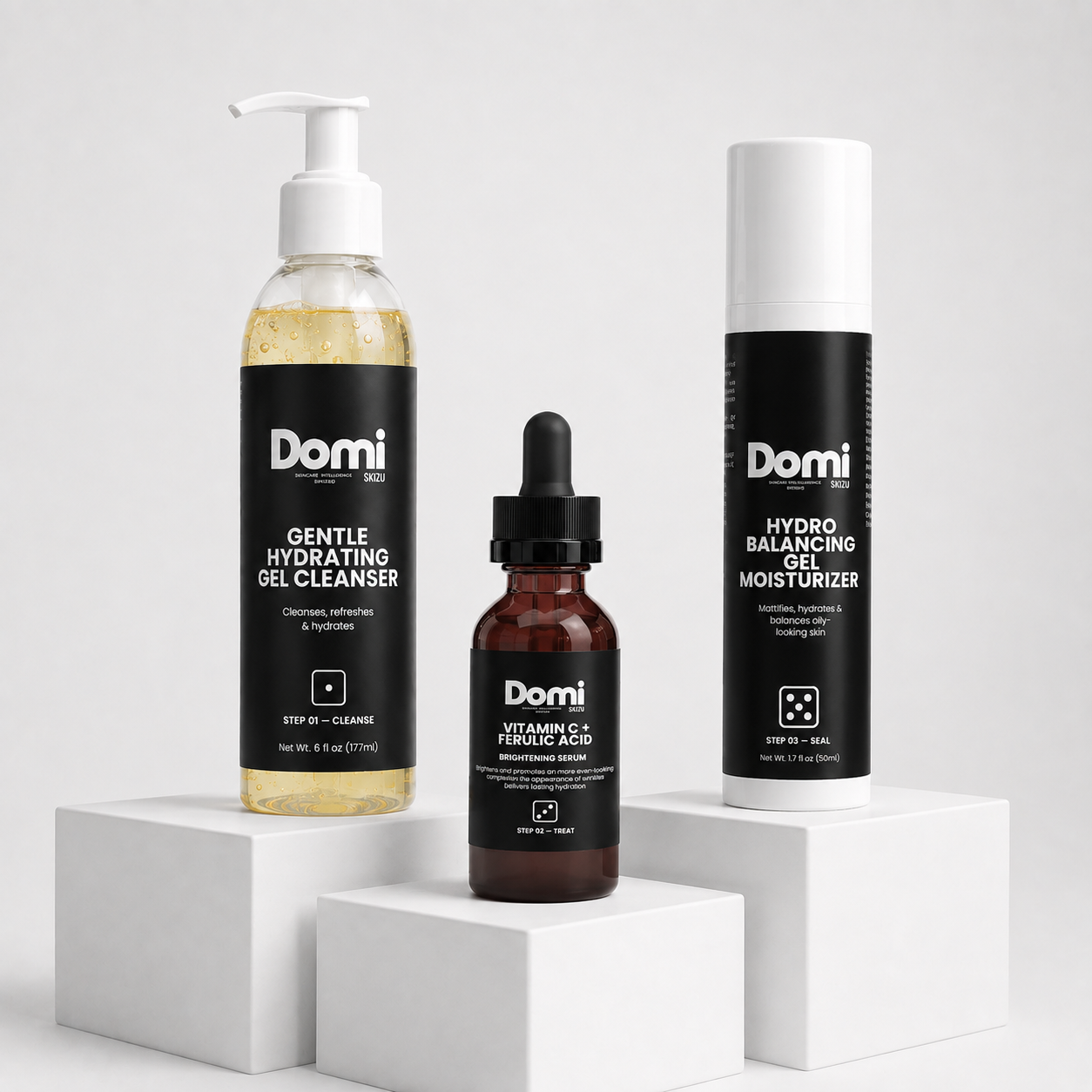 Three Domi skincare products displayed on white pedestals: a Gentle Hydrating Gel Cleanser bottle, a Vitamin C + Ferulic Acid dropper bottle, and a Hydro Balancing Gel Moisturizer tube, all with black labels and white tops.