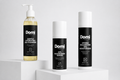 Three Domi skincare products displayed on white pedestals against a light gray background: a Gentle Hydrating Gel Cleanser in a clear pump bottle with yellow liquid, a 10% Niacinamide Serum in a black-and-white cylindrical bottle, and a Hydro Balancing Gel Moisturizer in a black-and-white aerosol can.