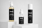 Three Domi skincare products displayed on white pedestals against a light gray background: a Gentle Hydrating Gel Cleanser bottle, a Hyaluronic Acid dropper bottle, and a Peptide Barrier Moisturizer canister.